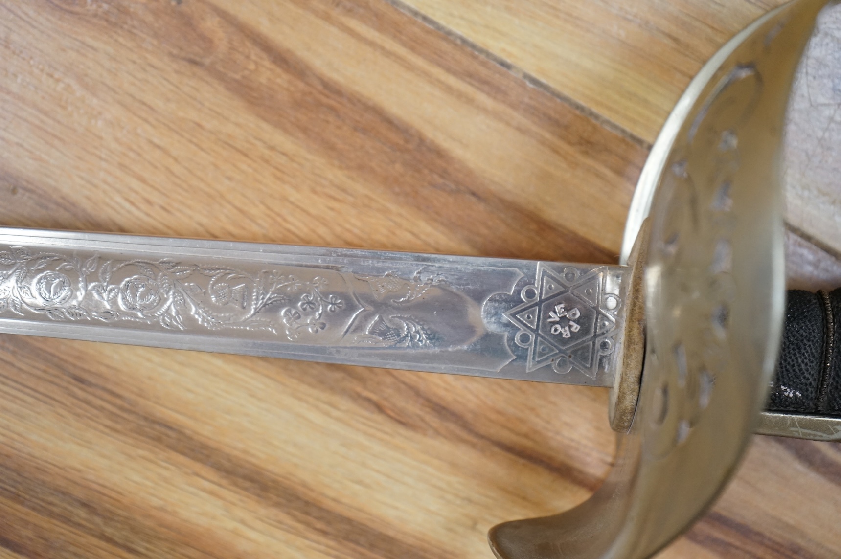 A George V 1897 pattern infantry officer’s sword, with regulation blade etched with the union flowers, Royal Arms and owners name; J.W. Reynolds, Dorrington, Lincoln, regulation nickel guard stamped ‘WH&S’ in minuscules,
